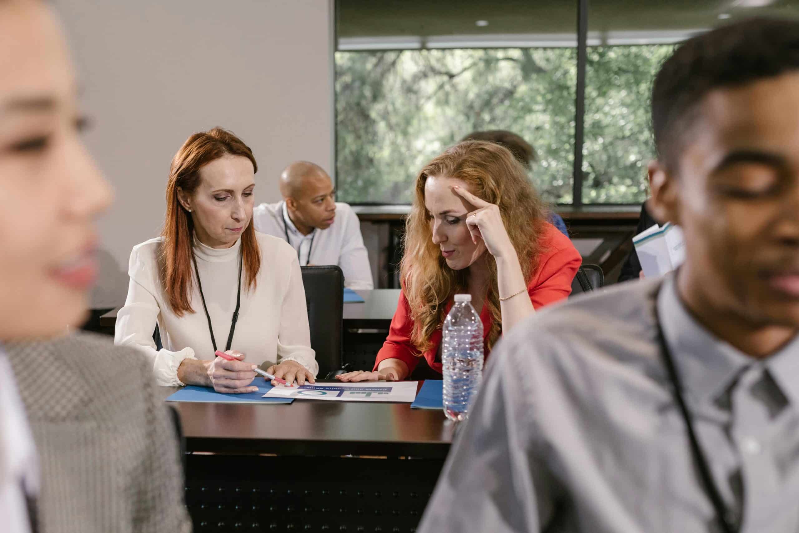 An engaging group mentoring session with diverse refugee candidates and employers networking and discussing. The image highlights direct interactions that bridge gaps in employment opportunities and showcase skills, promoting inclusivity and innovative hiring practices.