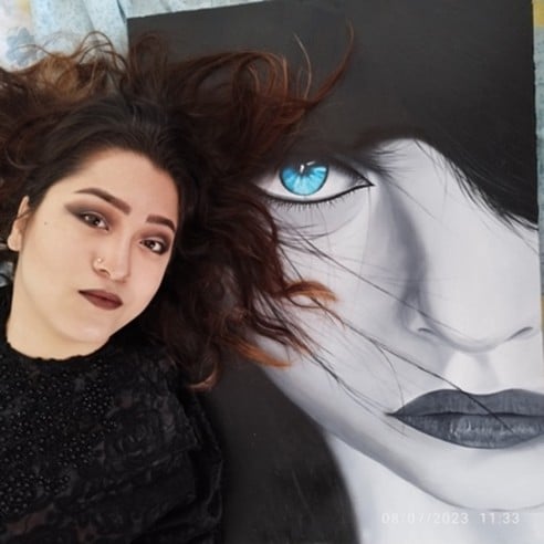 Robaba Mohammady next to one of her artworks.