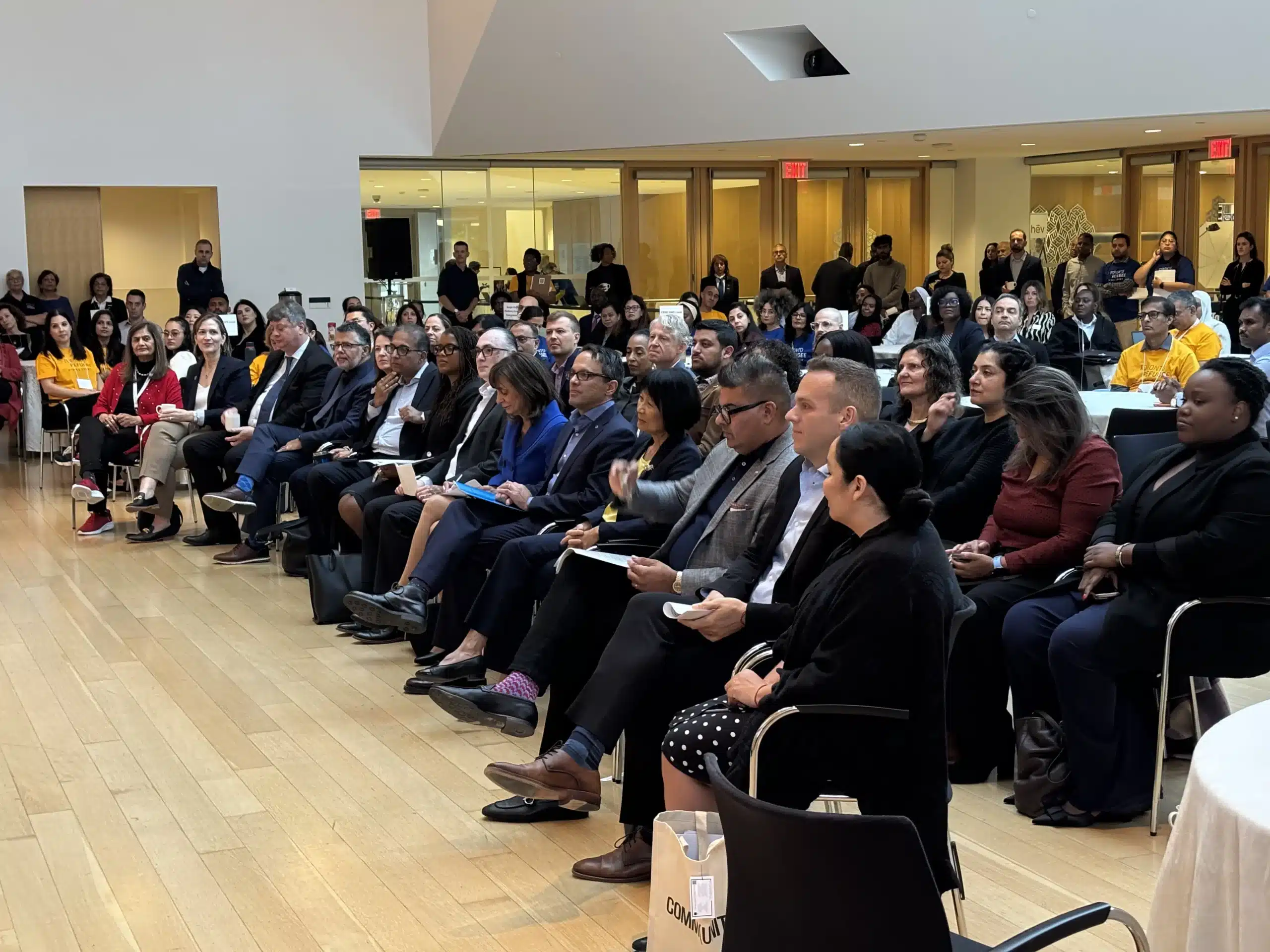Key leaders and partners stand together during the opening ceremony at the Toronto Refugee Hiring Event held at the Ismaili Centre.
