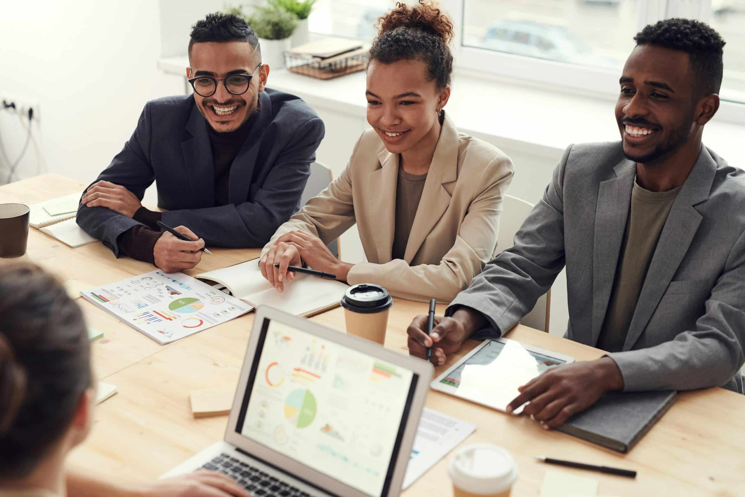 Refugees smiling and participating in panel interviews at a professional hiring event.