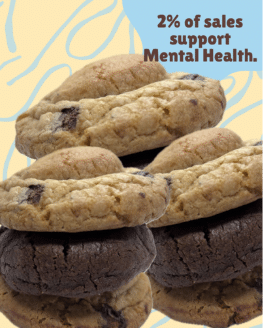 A close-up shot of three signature Chewy Puff cookies stacked on top of each other. The cookies are round, thick, and have a slightly crinkled, golden-brown exterior. They look soft and chewy. The image promotes a cause where 2% of the purchase price supports mental health.