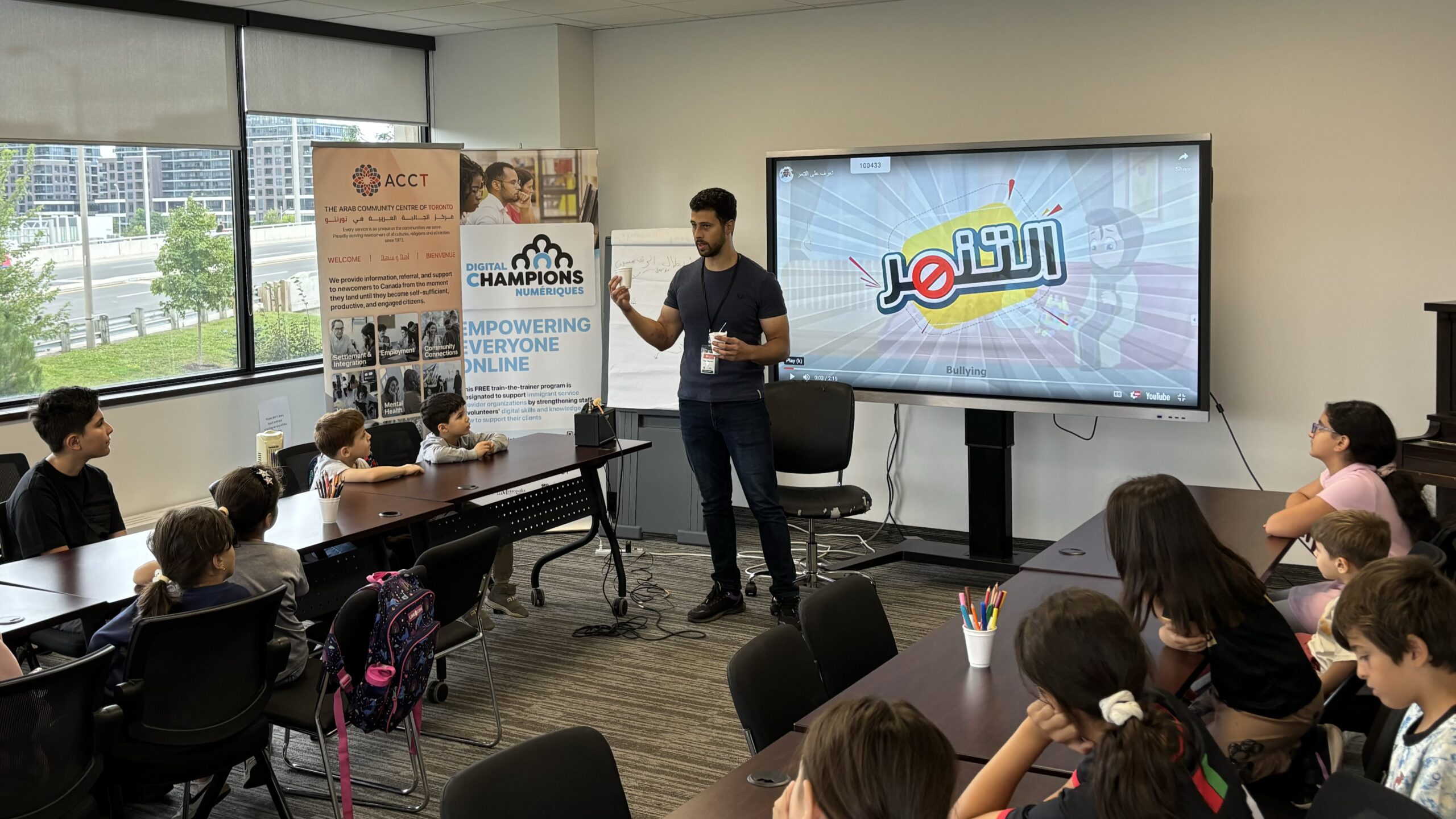 Yaseen facilitating an Arabic language workshop for children at the Arab Community Centre of Toronto (ACCT) using interactive activities.