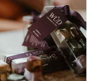 A gift bundle featuring one Infinity Chocolate Box and five Petite Chocolate Boxes arranged together.